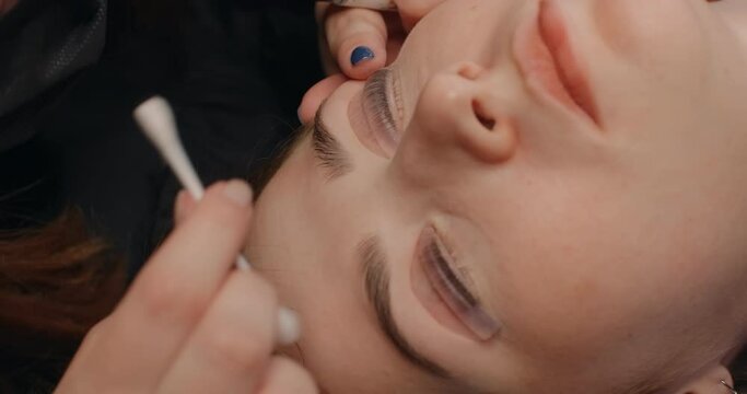 Lashmaker does the eyelash lamination procedure for the client in the beauty salon, cosmetic services, beauty care procedures, 4k 60p Prores HQ