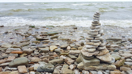 Fototapeta na wymiar memorial cairn stones on the beach