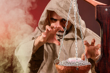 Old evil magician with a beard casts magic spells