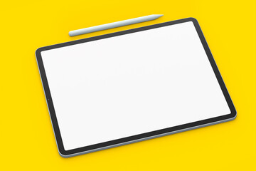 Computer tablet with pencil isolated on yellow background.