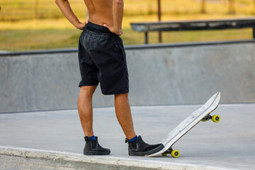 Fototapeta premium young male skateboarder with his board at a skatepark