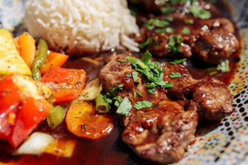 Oriental lamb fillet with rice and vegetables on a plate