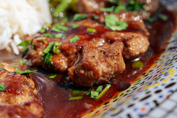 Oriental lamb fillet with rice and vegetables on a plate