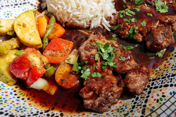 Oriental lamb fillet with rice and vegetables on a plate