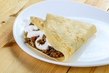 Pancake with minced meat and sauce