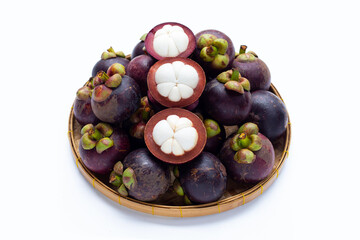 Mangosteen in bamboo basket on white background.
