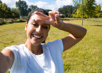 Girl taking a selfie in the park