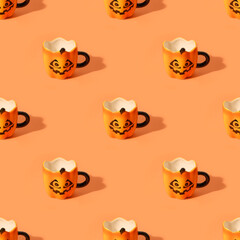 Seamless pattern of Halloween fun empty cups with face on orange background. Creative design.