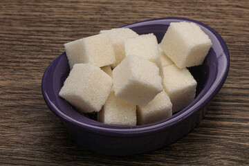 Refined white sugar cubs in the bowl