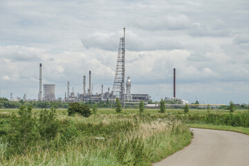 road in the countryside with industrial complex in background with power station
