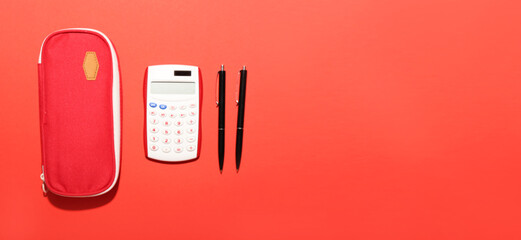 School stationery and calculator on color background with space for text