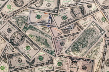 Assorted US Dollars overlapping sporadically ranging from $1 - $100. Each bill is from a different print year.