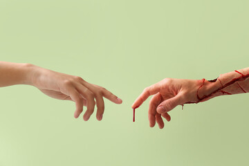 Hands of human and monster on color background. Halloween celebration