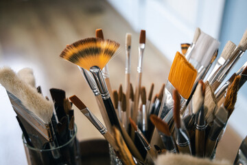 Group of fresh new paintbrushes. Assorted unused art supplies. Various different sizes and colors.