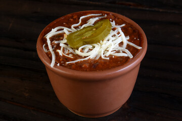 delicious Mexican beef chilli, beans and spices inside the canister isolated on black background.