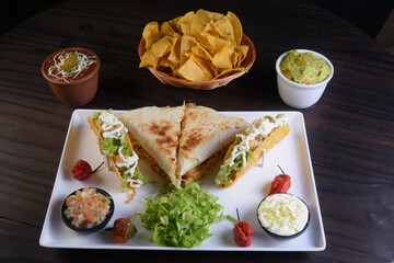 delicious mexican food tacos, guacamole, quesadillas, chilli, tortilla, burritos isolated on black background.
