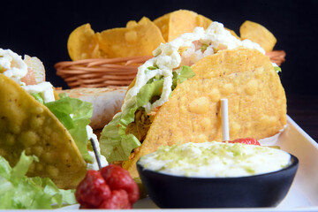 delicious mexican food tacos, guacamole, quesadillas, chilli, tortilla, burritos isolated on black background.