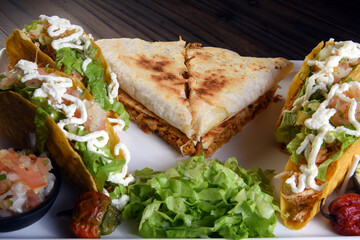 delicious mexican food tacos, guacamole, quesadillas, chilli, tortilla, burritos isolated on black background.
