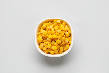 Bowl of corn kernels on white background