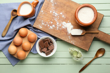 Ingredients for preparing churros on color wooden background
