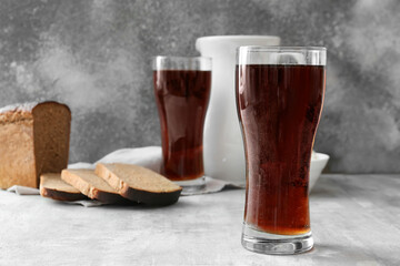 Glasses of fresh kvass on grey background