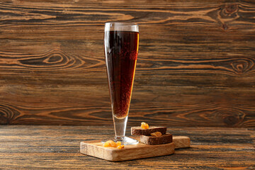 Glass of fresh kvass on wooden background