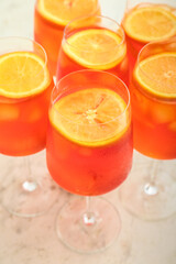 Glasses of Aperol spritz cocktail on light background