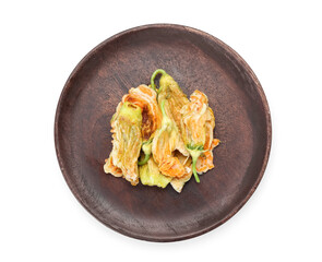 Plate with fried zucchini flowers on white background