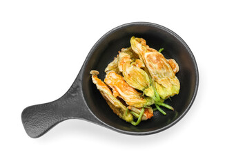 Frying pan with fried zucchini flowers on white background