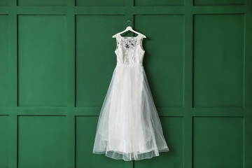 Beautiful wedding dress on color background