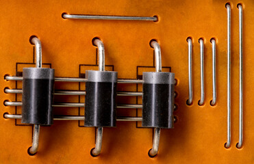 Integrated circuit board with soldered resistors. Electronic components attached to the circuit board.