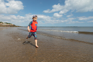 Boy running on a beach