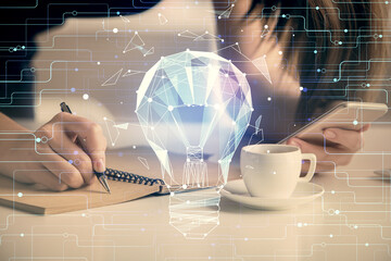 Double exposure of light bulb hologram and woman holding and using a mobile device. Idea concept.