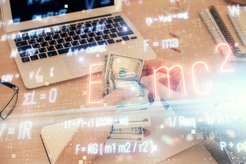 Multi exposure of Formulas drawing hologram and USA dollars bills and man hands. Education