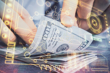 Double exposure of technology drawing hologram and us dollars bills and man hands. Data concept