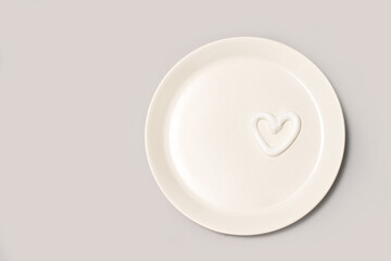 Heart shape cream. Beauty lotion. Mayonnaise smear on white plate. Top view with copyspace. White product smear. Valentine concept