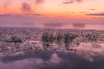 Fog covered lake early in the morning before sunrise