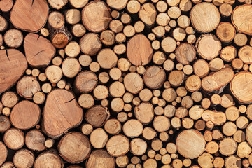 Pile stacked of natural sawn wooden logs background
