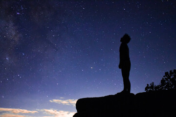 silhouette of a person staring at the stars