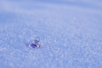 Christmas ornament in the snow with empty copy space for congratulations. Merry Christmas and happy new year. 