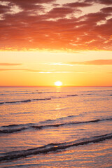 Fototapeta na wymiar Sunrise over the horizon over the sea at the beach in Darwin, Northern Territory, Australia