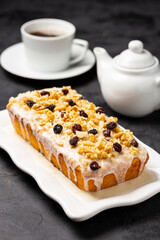 English cake topped with fondant, raisins and walnuts.