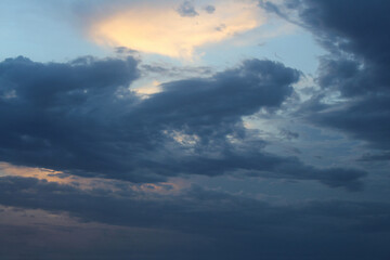 Dark grey clouds rolling in at sunset