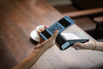 Close up woman hand holding using smartphone while making contactless payment at cafe,Mobile payment.