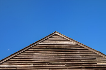 Wooden dilapidated A-frame set off against a deep azure blue sky