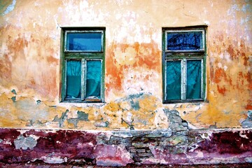 Artistic old house with two windows.