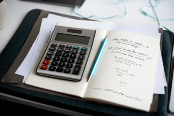 Startup business marketing strategy target profit calculation formula write on notebook