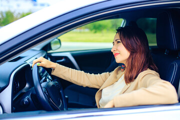 brunette middle age student woman in new car outdoor summer day