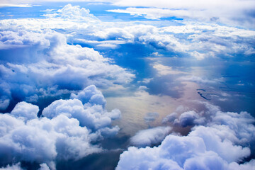 View of the clouds from above, looking down at the ocean.
