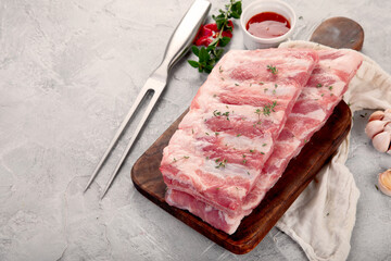 Raw ribs on ligth gray background. Gourmet cooking food concept.